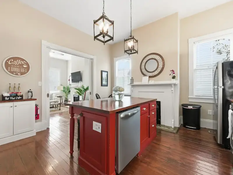 Suite 314A Wilder House kitchen and dining area — kitchen island with dining nook heart-pine floors