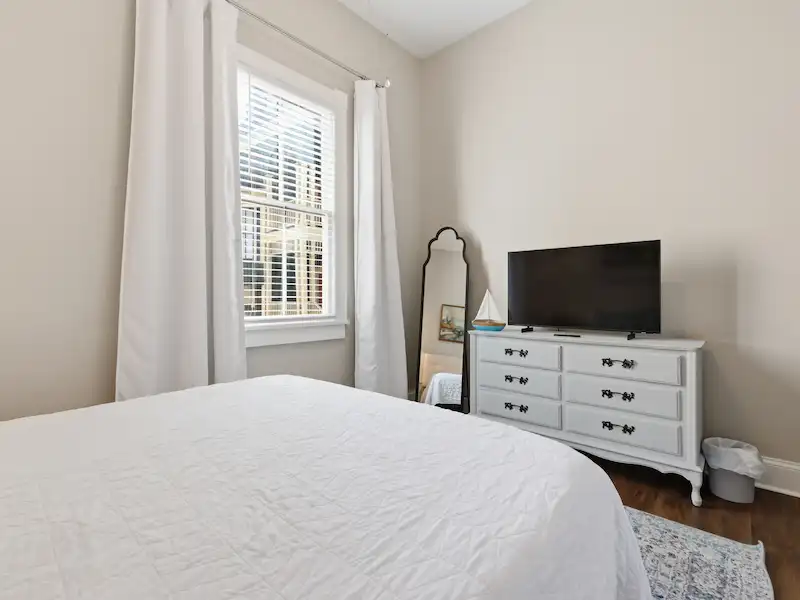 Suite 316A queen bedroom with natural light — Victorian District Savannah vacation rental